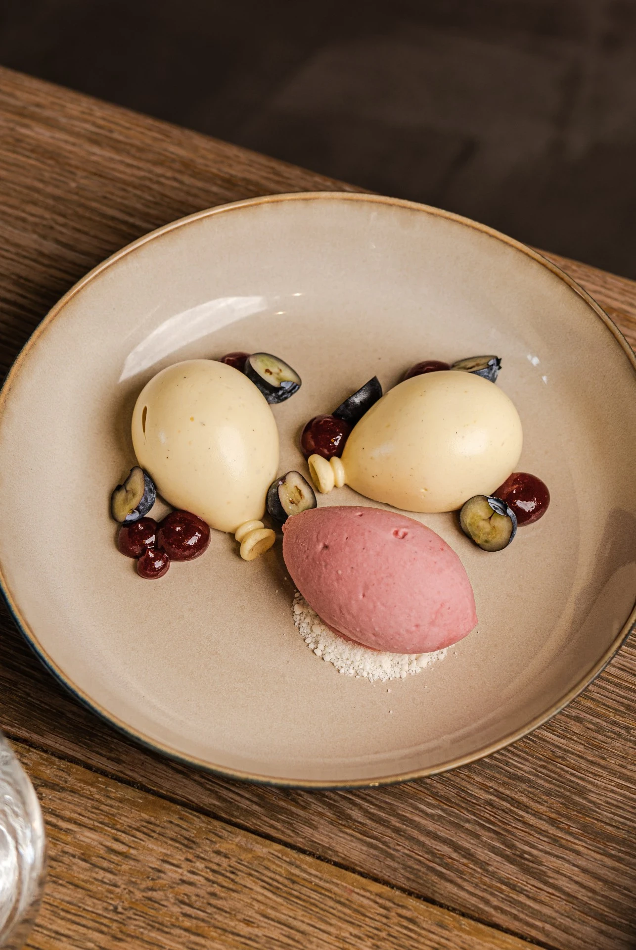 Festlig dessert med balloner af passionsfrugt mousse, hindbær gele og jordbær sorbet